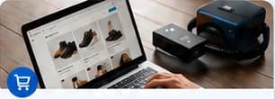 Digital store displayed on a laptop alongside technology equipment